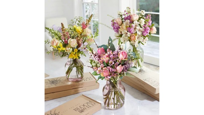 Three bouquets in vases and three Bloom & Wild subscription boxes.