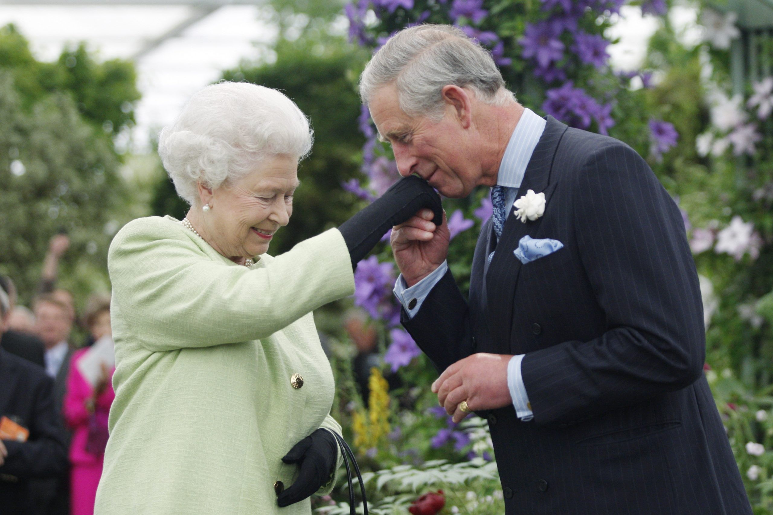 2009: Queen Elizabeth II presents Prince Charles, Prince of Wales with the Royal Horticultural Society's Victoria Medal of Honour during a visit to the Chelsea Flower Show in 2009 in London.