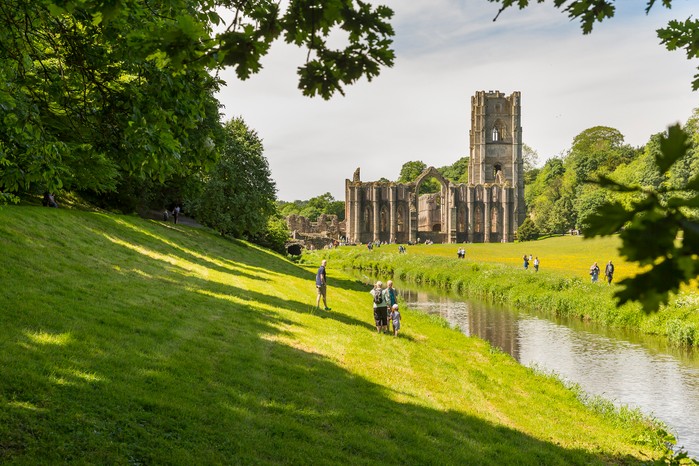 Visitors walking through the grounds of Fountains Abbey