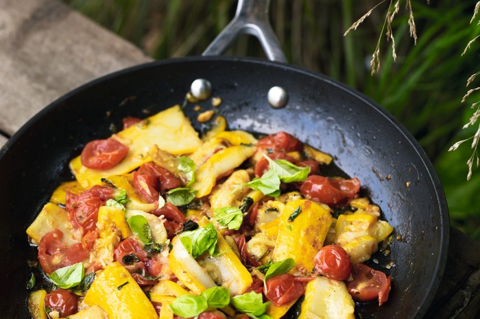 A stir fry dish of yellow courgette and tomatoes