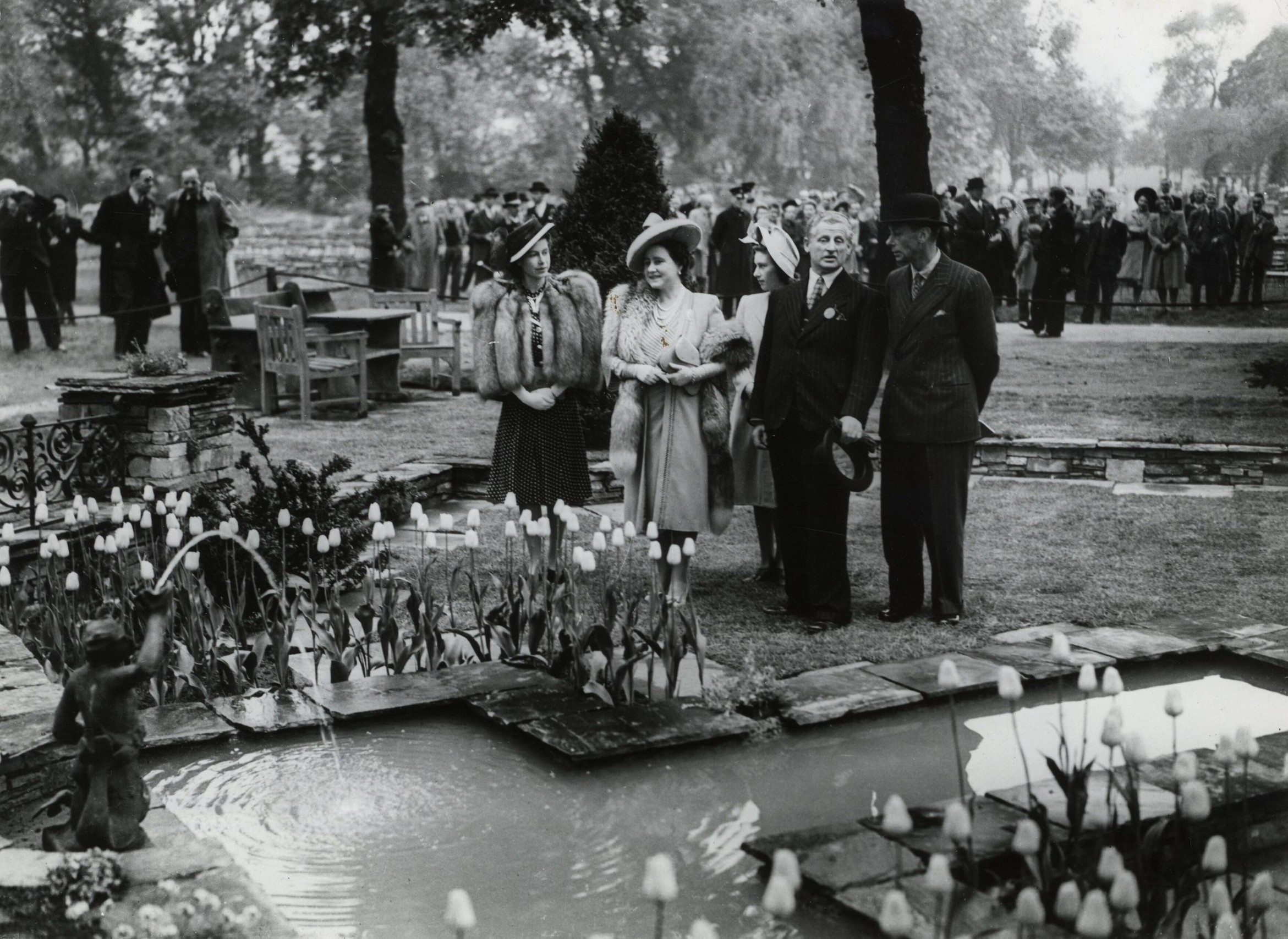 1947: Royal party by formal pond at the RHS Chelsea Flower Show.