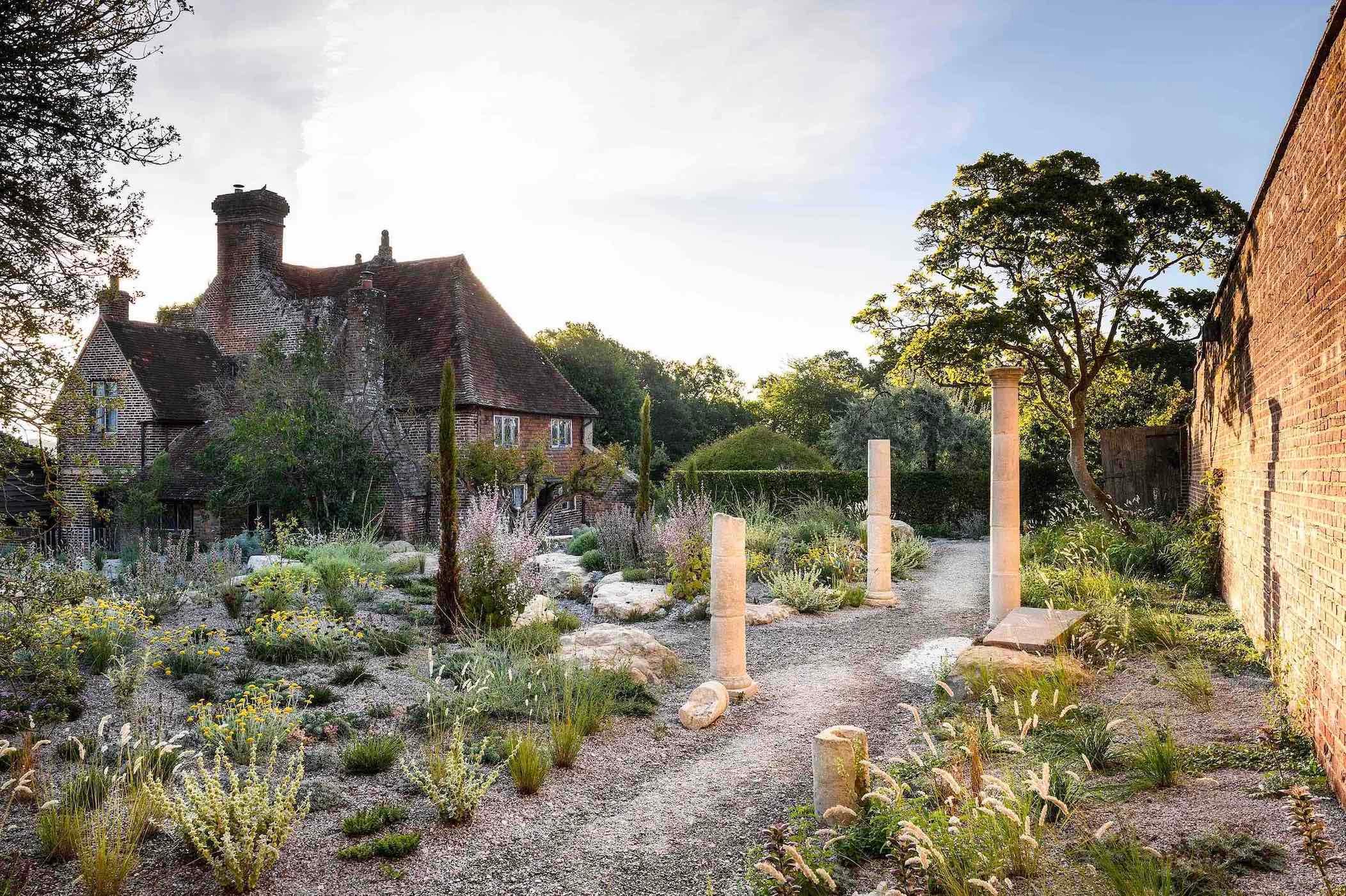 The stone columns, which came from High Wall, a Harold Peto-designed garden in Oxfordshire, have been reconstructed here, just as they have been on the island of Delos, to give a sense of original architecture, supported by ground-level planting that evokes the Greek phrygana